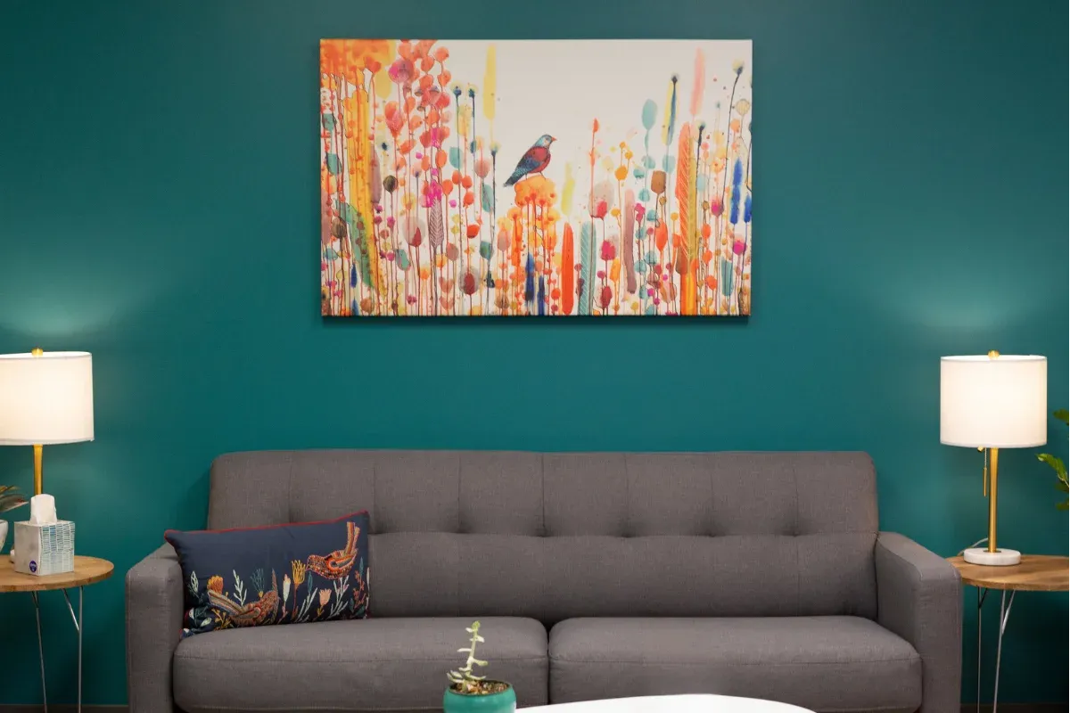 The lobby at Center for Compassion in Chandler, Arizona — soft seating, warm light, and a painting on the wall