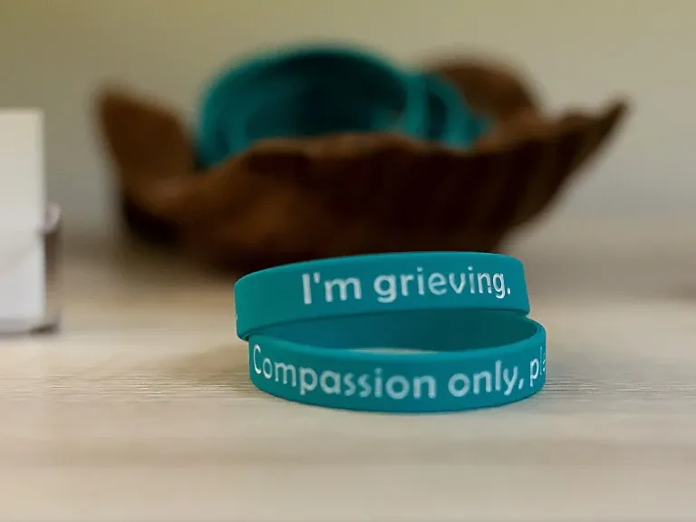 A table at Center for Compassion holding remembrance bands for grieving clients
